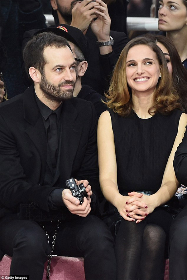 当地时间1月26日，娜塔丽·波特曼 (Natalie Portman) 身穿灰色七分袖大衣搭配同色丝质半身裙亮相2015春夏巴黎高定时装周迪奥 (Dior) 秀场前排，与老公Benjamin Millepied大秀恩爱羡煞旁人！